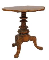 A Victorian walnut occasional table, the shaped walnut top inset with star marquetry, on an