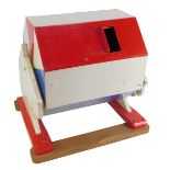 A mid century painted tombola drum, in red, white and blue, with sliding drawer, with a carved horse