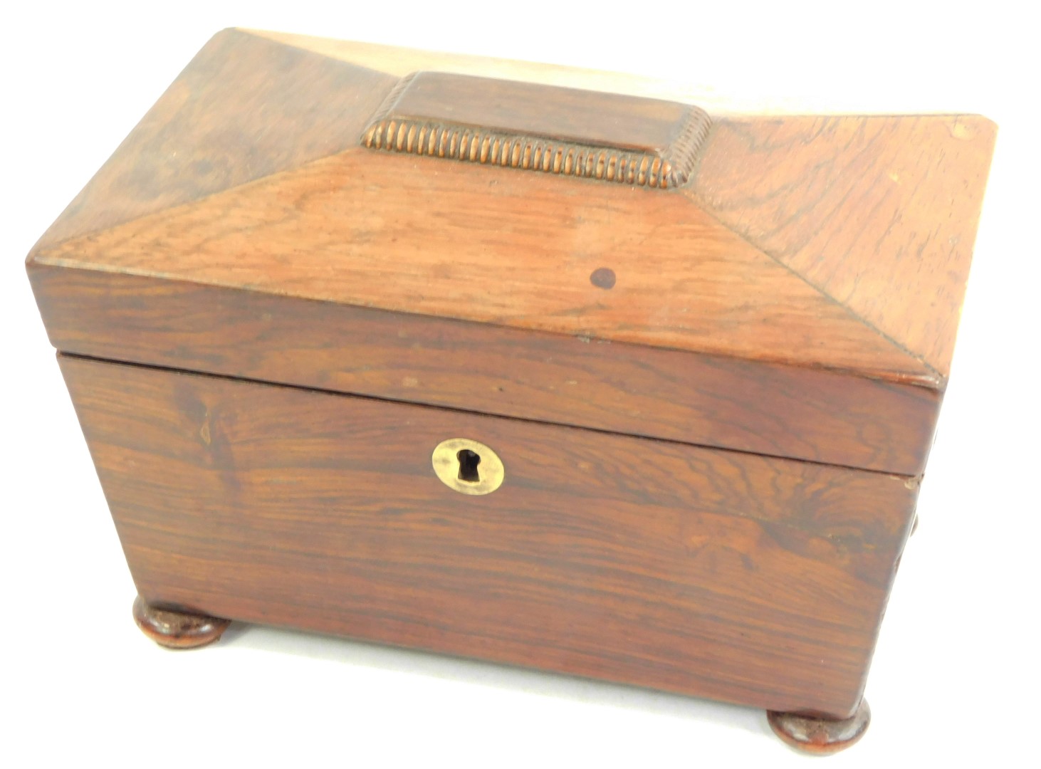 A Regency rosewood sarcophagus shaped tea caddy, the hinged lid enclosing two lidded compartments,