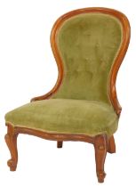 A Victorian mahogany spoon back nursing chair, with green draylon overstuffed seat and back, on