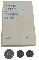A George III cartwheel penny, two George III pennies, heavily rubbed, and a standard catalogue of