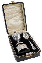 A George VI cased silver Christening set, comprising egg, spoon and napkin rings, each bearing the