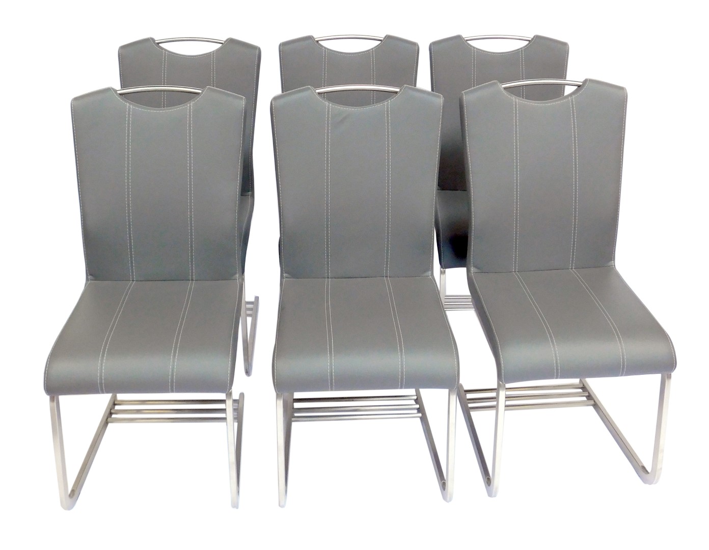 A set of six modern dining chairs, each with a grey leatherette seat and back, with cream stitching,