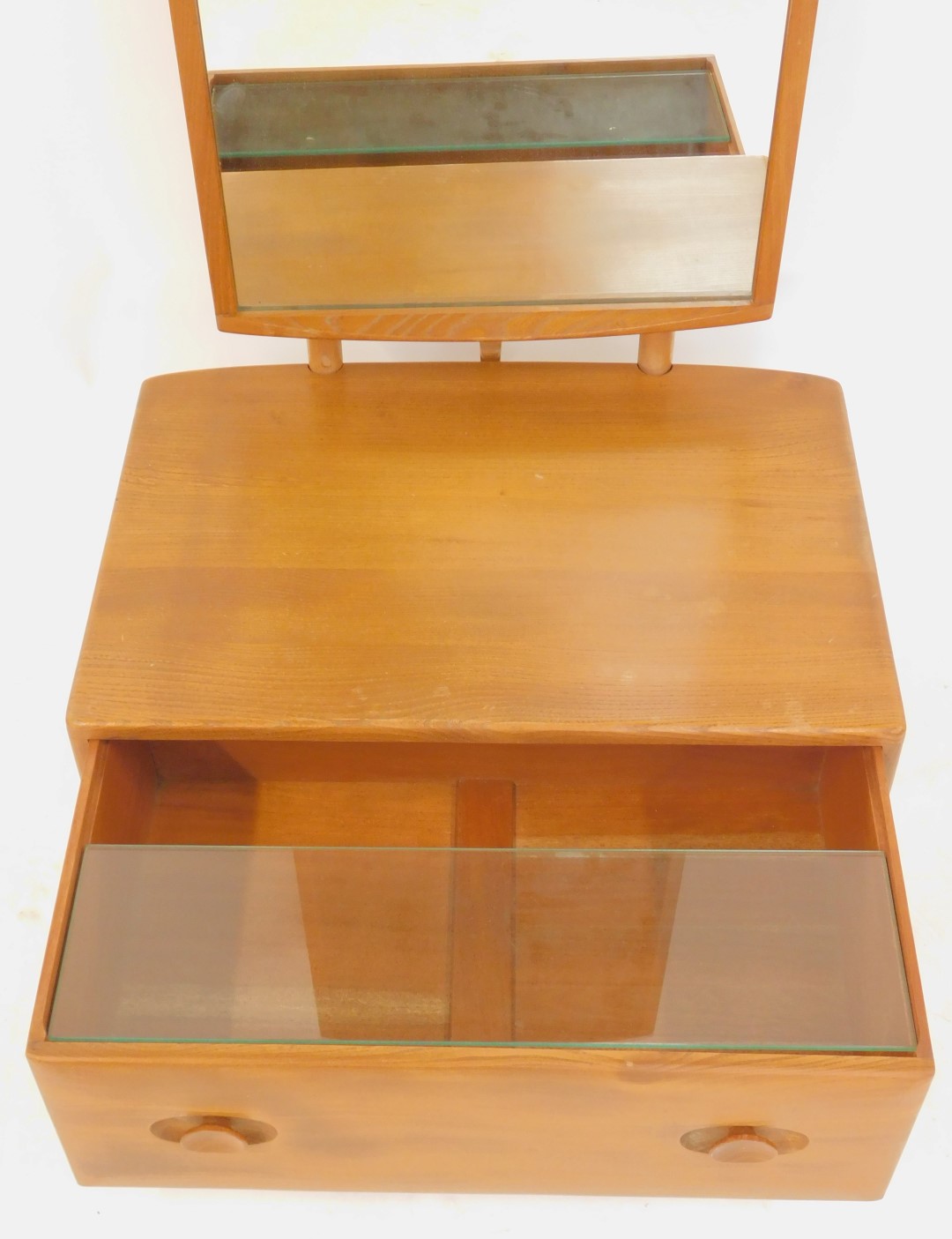 An Ercol cheval mirror, the mirror plate of rectangular form, above a base with drawer, on - Image 2 of 2
