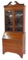 A late 19thC mahogany and inlaid bureau bookcase, the top with swan neck pediment above a