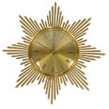 A mid century Junghans ATO-MAT brass sunburst wall clock, with brass circular dial bearing Roman