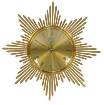 A mid century Junghans ATO-MAT brass sunburst wall clock, with brass circular dial bearing Roman