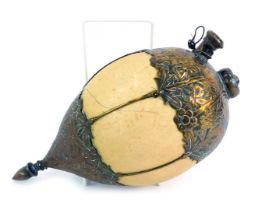 A Middle Eastern ostrich egg drinking vessel, with brass mounts to top and base, decorated with