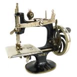 A miniature Singer sewing machine, stamped The Singer Manufacturing Company USA, 17cm high.