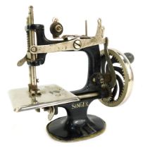 A miniature Singer sewing machine, stamped The Singer Manufacturing Company USA, 17cm high.