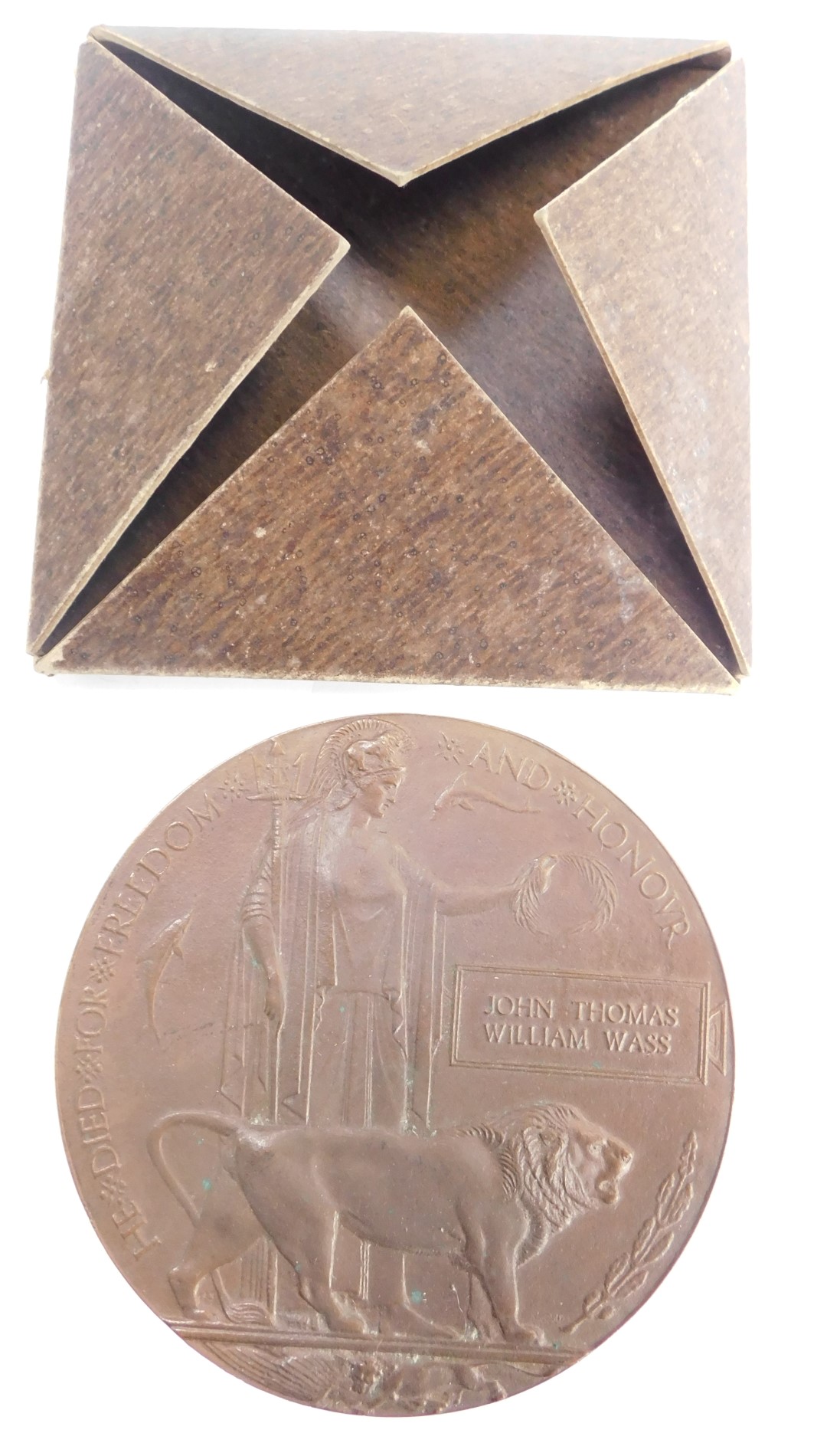 A WWI death plaque, awarded to John Thomas William Wass, in sleeve.