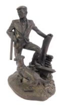 A 20thC resin figure group, depicting a gentleman in shooting attire, with cocked gun beside dog,