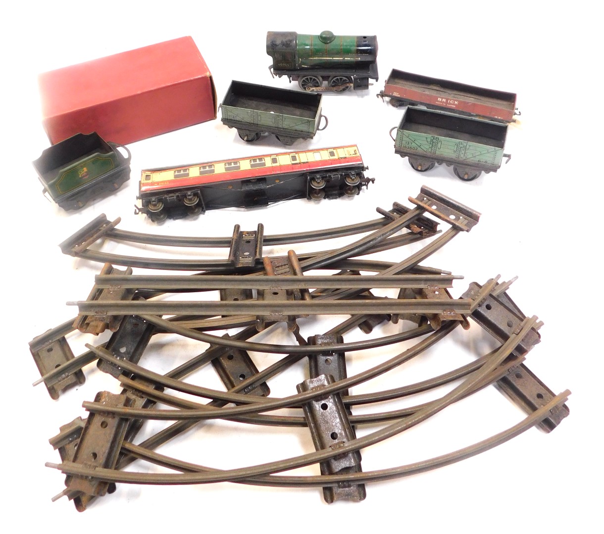 A Hornby O gauge clockwork tinplate train set, including 0-4-0 locomotive, plank wagons and track.