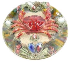 A 20thC Portuguese Caldas da Rainha majolica plate, decorated with a crab amongst shells and