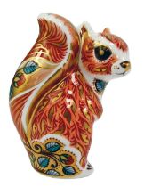 A Royal Crown Derby porcelain woodland squirrel paperweight, red printed marks and gold stopper,