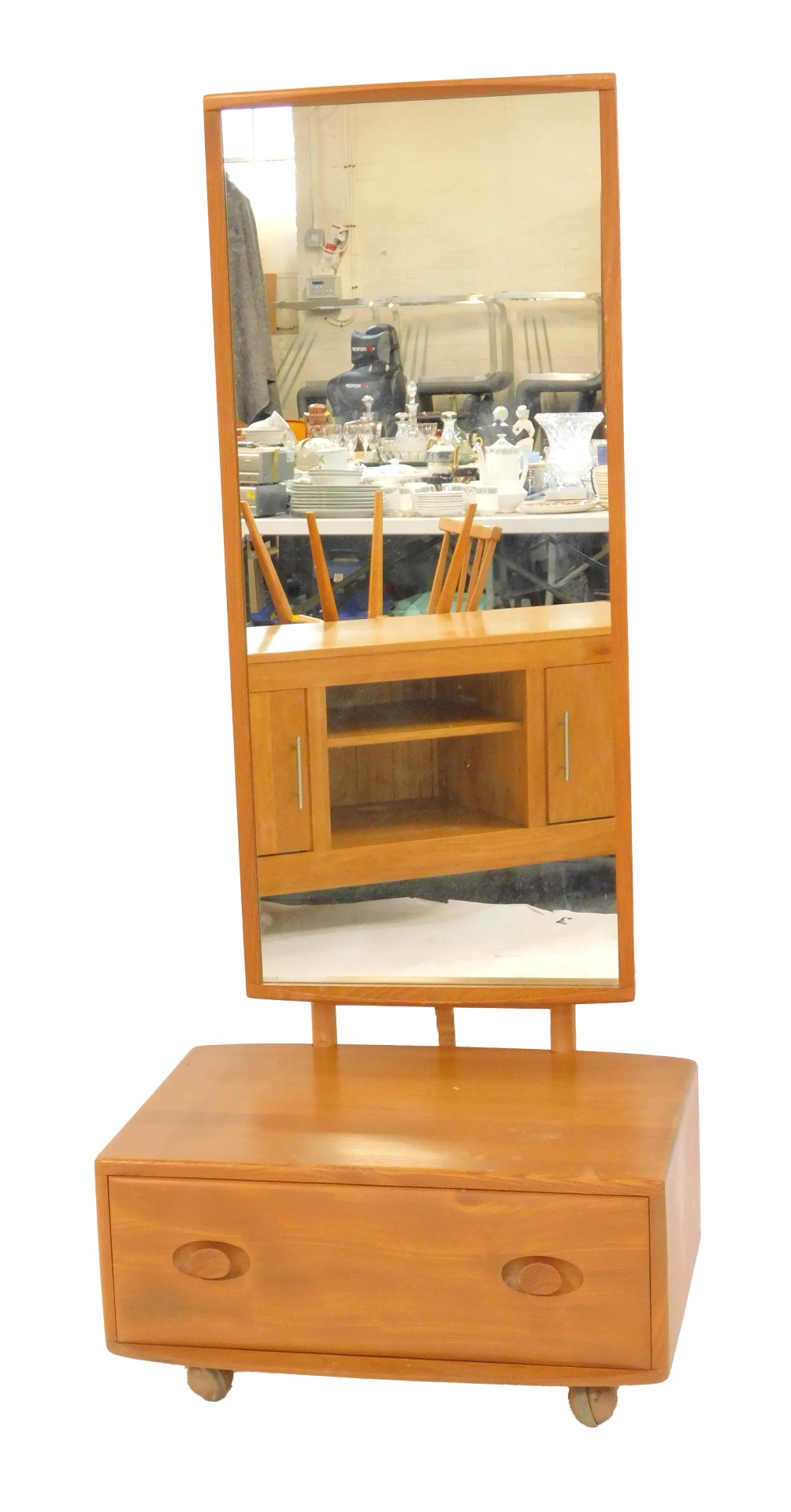 An Ercol cheval mirror, the mirror plate of rectangular form, above a base with drawer, on
