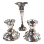 A pair of silver dwarf candlesticks, each of plain design, on a waisted foot, with rubbed hallmarks,