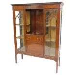 An Edwardian mahogany and boxwood inlaid cabinet, the top with a moulded cornice above a central