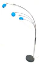 A Scandinavian style five arm arched chrome floor lamp, with blue frosted glass shades, on a