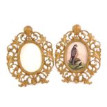 A pair of late 19th/early 20thC gilt metal photograph frames, each with an oval crest, with arched