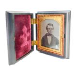 A late 19thC daguerreotype portrait, in a fitted ebonised case, with raised and applied scroll