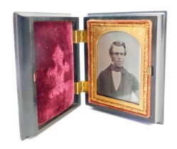 A late 19thC daguerreotype portrait, in a fitted ebonised case, with raised and applied scroll
