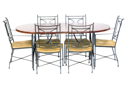 A modern hardwood oval dining table, raised on X shaped wrought iron end supports, 77cm high, the - Image 1 of 4