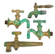 A group of brass taps, comprising a Victory Cask tap, 21cm high, a pair of water faucets, and a