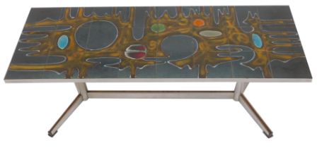 A 1970s chrome framed tile top coffee table, the top decorated with an abstract roundel and drip