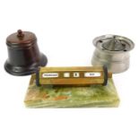 Desk related items, comprising a pewter inkwell, 7cm high, a turned wooden inkwell, 8cm high, and