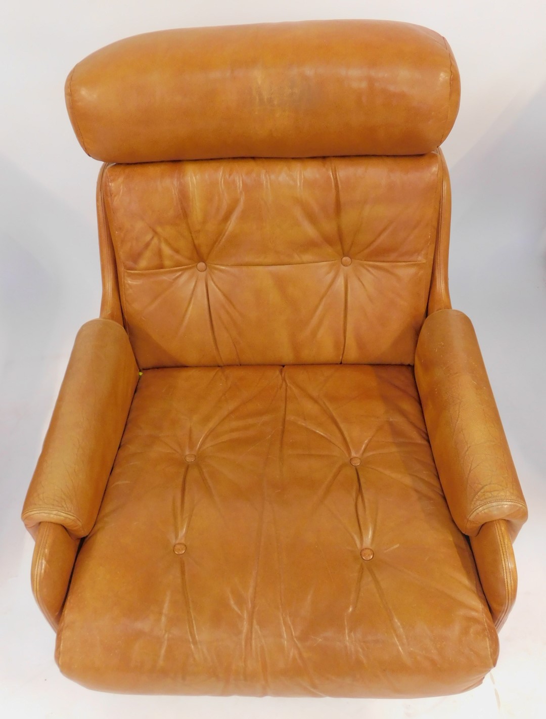 A pair of 1970s brown leather armchairs, each with a headrest, buttoned back and seat, on castors, - Image 2 of 2
