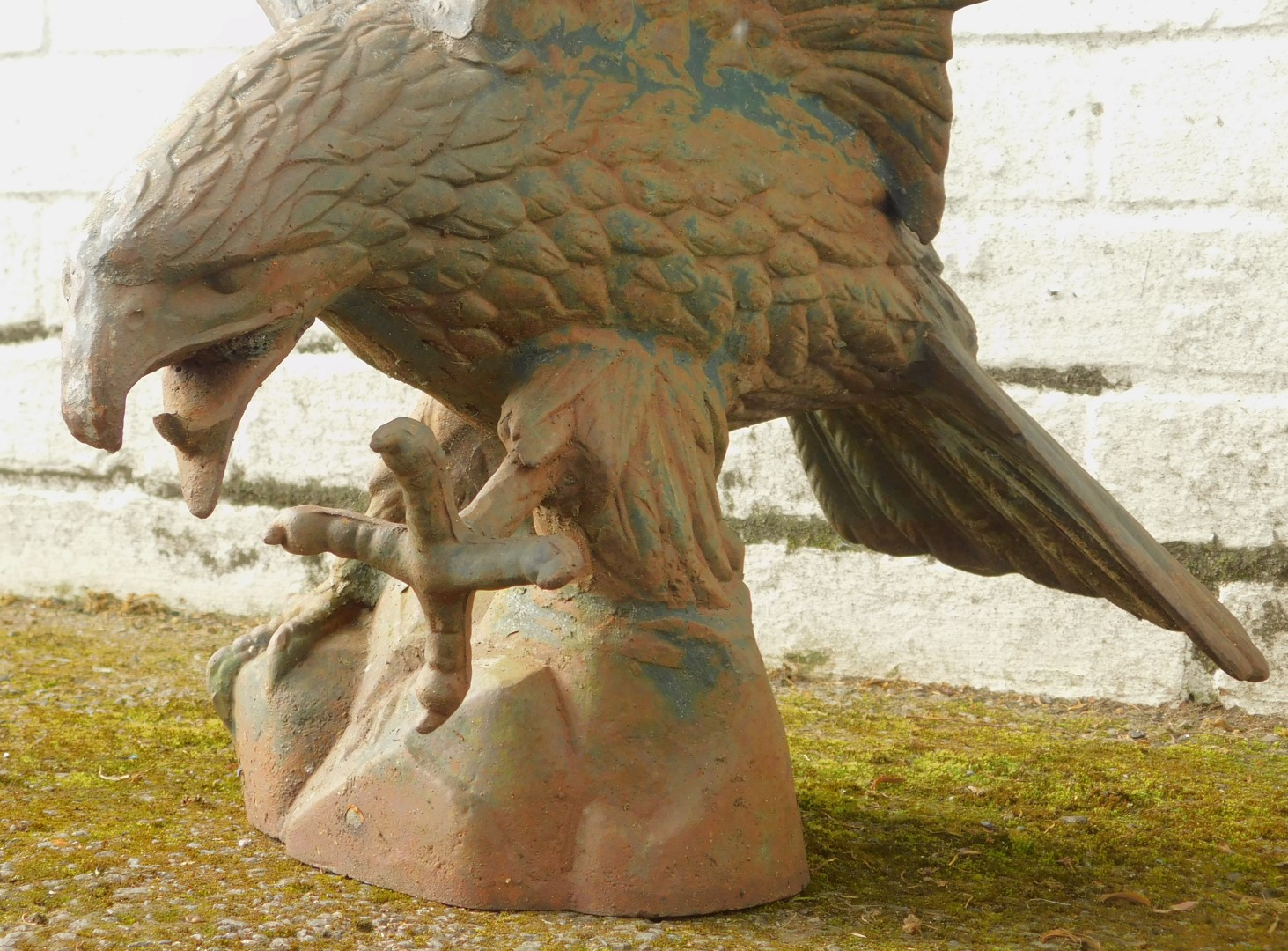 A cast metal figure modelled as an eagle, with wings outswept standing on a rocky plinth, 64cm - Image 3 of 3