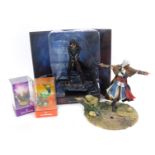 An Xbox One Assasin's Creed Syndicate game statue, together with an Elite Voodoo figure, etc.
