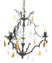 A cast metal three branch chandelier, with moulded glass central column and various clear and