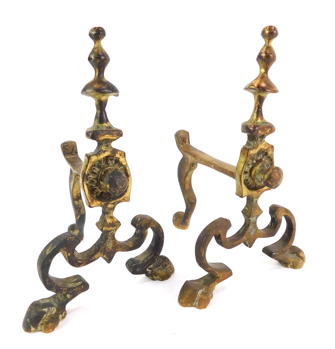 A pair of brass fire dogs, 23cm high.