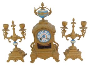 A 19thC French gilt metal and enamelled clock garniture, the white enamel circular dial bearing