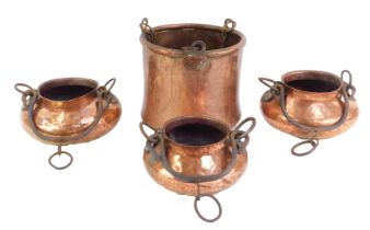 Three Eastern copper vessels, each of hammered cylindrical form with raised neck, wrought metal ring