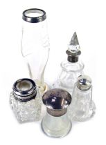 Five Edward VII and later silver topped cut glass bottles and jars, including a scent bottle and