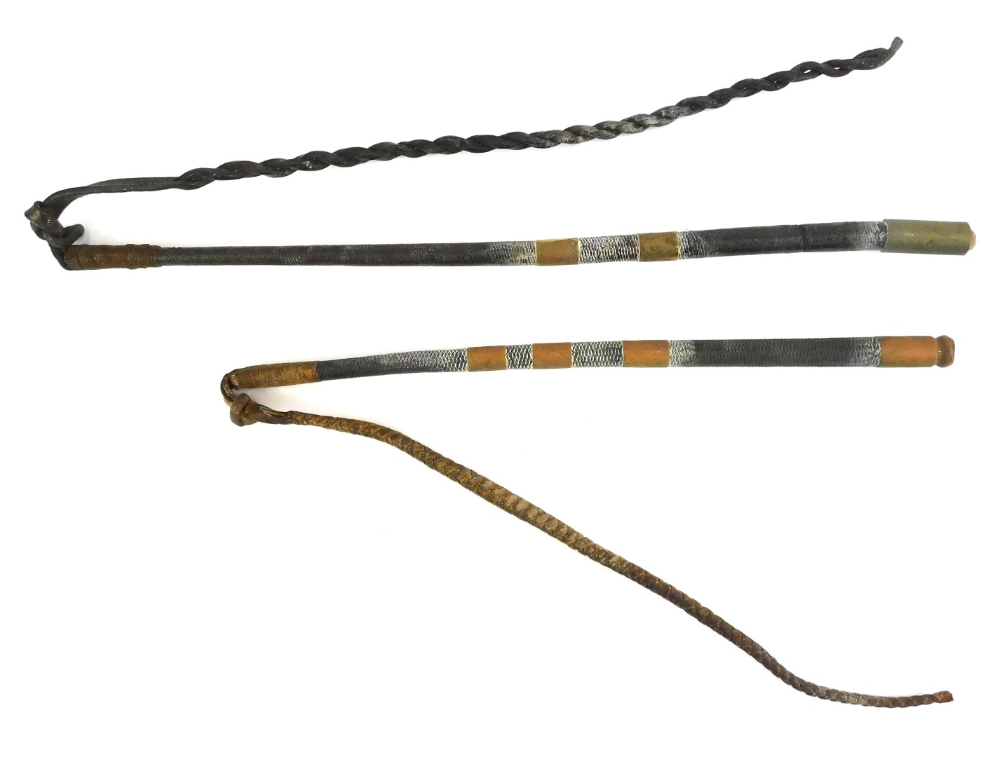 Two similar leather riding whips, each with a leather handle, with copper banding and braided