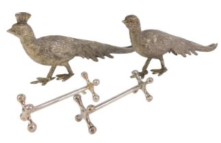 A pair of cast metal menu holders, modelled as pheasants, 23cm long, together with a pair of knife