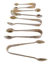 Five pairs of Edward VII and later silver tongs, variously decorated, 2.36oz.