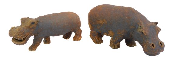 A pair of early 20thC studio pottery figures modelled as hippos, indistinctly signed to underside,