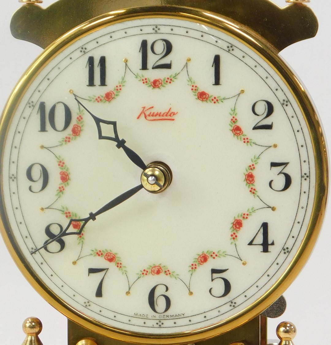 A 20thC German Kundo brass anniversary clock, the cream circular dial bearing Arabic numerals, key - Image 2 of 4