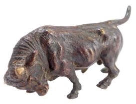 A 19thC bronze figure of a bull, unmarked, with later wooden horns, 10cm wide.