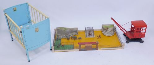 A Chiltern Toys metal and wooden framed toy cot, together with a mid century zoo play set, with