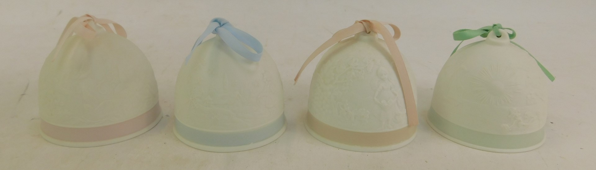 Four Lladro white matt porcelain bells, Collectors Society 1992, each with a coloured ribbon, relief - Image 2 of 4