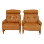 A pair of 1970s brown leather armchairs, each with a headrest, buttoned back and seat, on castors,