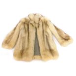 A fur short jacket, in white and brown, possibly fox, underarm measurement approx 36cm wide.