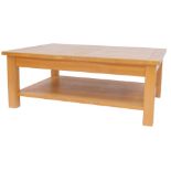 A Halo oak two tier coffee table, the rectangular top with carved line sections, raised on stiles,