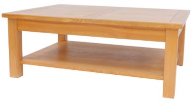 A Halo oak two tier coffee table, the rectangular top with carved line sections, raised on stiles,